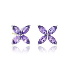 Be the star of the show with stunning earrings featuring marquis-cut amethysts in a design of understated elegance. Since 1861, Gump's has been a destination for jewelry that is distinctive and timeless. To ensure each piece is created to our exacting standards, our expert in-house jewelry team oversees every step of the production process. The result is a statement of pure elegance. Amethyst, 2.64ctw. Sterling silver. 14-karat yellow gold posts. Pierced only. 1/2"L x 1/2"W. Stunning Earrings, Star Earrings, The Star, Amethyst, Yellow Gold, Stud Earrings, Pure Products, Stars, Sterling Silver