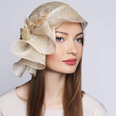 TIMELESS BEAUTY EXUDES AN AURA OF BLISS AROUND YOU Couture Hat with Bow and Brooch Kentucky Derby Wedding Headwear *Sizes: 57cm(22,4 inches); 59cm(23,23 inches) *Handmade; *High-quality sinamay fabric 100% natural Abaca palm fiber; This beautiful women's couture cloche with golden trim&brooch looks amazingly stunning and ideally accessorizes a multitude of your apparel. Whether you choose a classical dress or a modern and stylish outfit for the upcoming event, this cloche will surely bring out the magnetism and charisma you are looking for. Created using high-quality handwoven sinamay fiber which is so lightweight, and breathable.  With an asymmetrical brim. The bow in tone is added for charm.  Grosgrain inside for a better posture. 📌Sinamay is a material that consists of 100% abaca fiber Fitted Gold Fascinator, Gold Fitted Fascinator, Elegant Gold Headpieces For Ceremony, Fitted Cream Bridal Accessories, Elegant Cream Headpieces For Wedding, Elegant Cream Wedding Headpiece, Elegant Gold Headpieces For Kentucky Derby, Fitted Bridal Accessories For Church, Adjustable Bridal Accessories For Evening