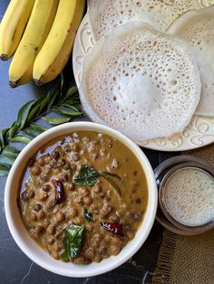 a bowl of food next to some bananas