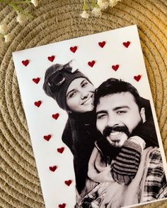 a couple holding each other with hearts on the wall next to them and a card that says, love is in the air