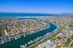 an aerial view of a city with boats in the water