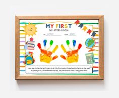 a wooden frame with two children's handprints on it and the words, my first day of school