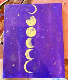 an acrylic painting with the word moon painted on it in yellow and purple