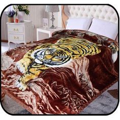 a bed with a tiger blanket on top of it