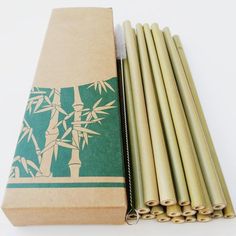 several bamboo sticks are sitting next to a cardboard box