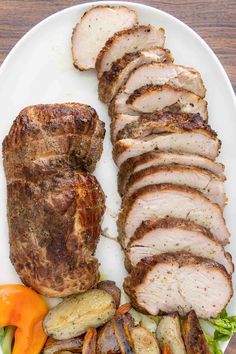 sliced meat and vegetables on a white plate