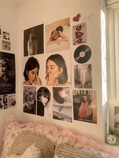 a bedroom with many pictures on the wall