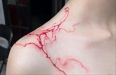 a close up of a person's shoulder with blood on it