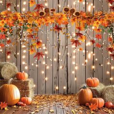 pumpkins and hay bales with lights in the background