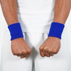 a man wearing blue wristbands and white pants