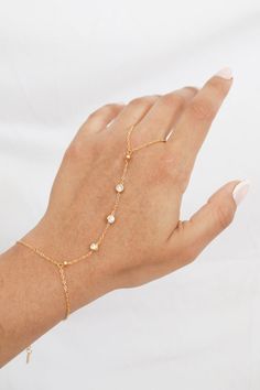 Let your hand do the talking with our Lucy CZ Hand Chain. Adorned with sparkling CZ stones, this delicate hand chain adds a subtle shine to any outfit. Perfect for any occasion, its effortless style will make you feel chic. Stack it with other dainty bracelets and rings for a personalized touch! All of our jewelry comes with a free jewelry pouch and cloth to keep your pretties safe and clean. Details Color: PVD 18K Gold PlatedMaterial: Stainless Steel Care Guide Store in a dry, cool place away f Spiral Shell, Bracelets And Rings, 40th Gifts, Dope Jewelry, Chic Gifts, Cuff Rings, Hand Chain, Dainty Bracelets, Shell Earrings