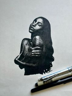 a black and white drawing of a woman holding a baby in her arms, next to two markers