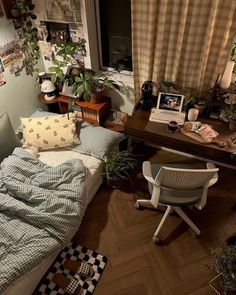 a small bedroom with a bed, desk and computer on top of the dresser next to it