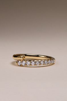 a yellow gold wedding ring with five diamonds on it's side, set in 18k yellow gold