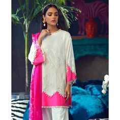 Pakistani Lawn Collection 2020 emblazoned with beautiful print and embroidered organza patch. Sana Safinaz Summer Collection is very stylish and you can wear these dresses on Party or Eid Events. Buy Online Sana Safinaz new collection at this store and change your look. Shirt: Pretty Shirt in white color is embellished with printed front and back on lawn fabric. Sleeves are also printed. Daman is embellished with organza patch in pink color. Trouser: Beautiful dyed trouser in matching color is a Lawn Designs, Embroidery Organza, Dresses Pakistani, Lawn Dresses, Pakistani Designer Clothes, Pakistani Suits Online, Pakistani Designer Suits, Pakistani Lawn Suits, Sana Safinaz