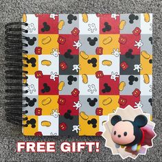 a mickey mouse notebook with the words free gift on it and an image of minnie mouse