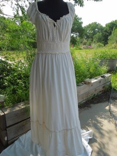 This is a sweet peasant dress made for Old Navy.  It is ankle length and has short sleeves and an elastic waist.  It has a bow tie at the bodice. The size says it's a Large.  It is cotton and it is lined (to the top of the bottom ruffle). Measurements: Shoulder to hem: 48 1/2" Shoulder to shoulder: 11" Waist: 15" (is stretchy) Hips: full Underarm to underarm: 17" Neck to top of elastic waist band: 8" Neck to bottom of elastic waist band: 11 1/2" All my items come from my smoke-free home however because they are vintage they have a prior history I know nothing about.  It is not uncommon for items to show some signs of wear.  I carefully inspect each item and give you an accurate and informed description as much as possible.  If I make repairs I let you know.  If there are rips or stains I a Spring Peasant Dress For Garden Party, Summer Prairie Dress With Empire Waist For Garden Party, Empire Waist Prairie Dress For Summer Garden Party, Summer Cotton Peasant Prairie Dress, Summer Cotton Prairie Peasant Dress, Summer Peasant Maxi Dress, Cottagecore Short Sleeve Maxi Dress For Garden Party, Cottagecore Maxi Dress With Short Sleeves For Garden Party, Cotton Peasant Maxi Dress For Summer