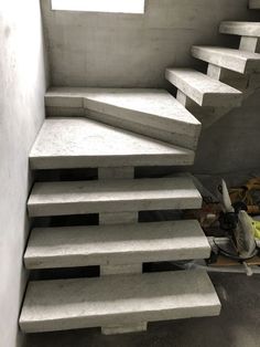 the stairs are made from concrete and have been placed in an area with no walls