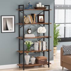 a living room with blue walls and shelves filled with books, vases and other items