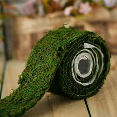 a roll of moss sitting on top of a wooden floor