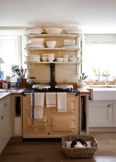 an old fashioned stove in a kitchen with dishes on it