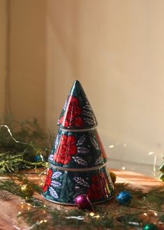 a decorated christmas tree sitting on top of a wooden table