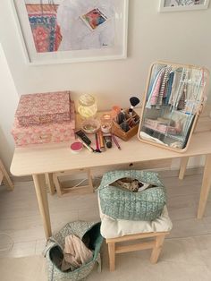 a wooden table topped with lots of makeup and personal care items next to a mirror