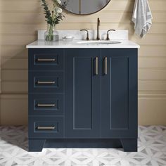 a bathroom vanity with two sinks and a round mirror