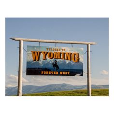 a sign for wyoming with mountains in the background