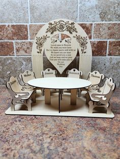 a white table with chairs and a heart shaped sign on the wall in front of it