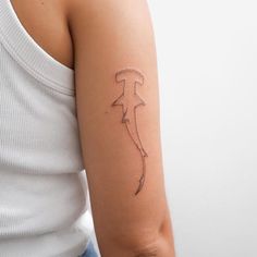 a woman's arm with a tattoo on it that has an arrow in the middle