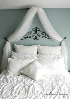 the bed is made with white sheets and pillows