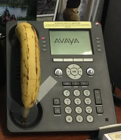 a banana sitting on top of an ava phone