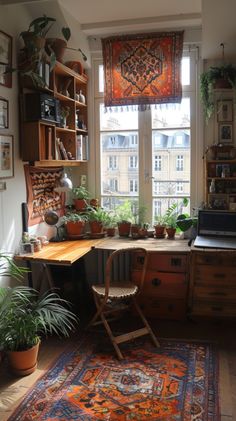 a room filled with lots of potted plants on top of a table next to a window