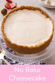 a no bake cheesecake on a glass plate with strawberries in the background