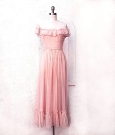 Dreamy pale pink silk organza gown from the 40s with ruffles at the yoke and hem. The skirt is gathered to the natural waist and has ruffles down the back. It is fully lined and has a side metal zipper. Beautiful bride or bridesmaid dress. X Small size it was tight on the size 4 dress form. Measurements with room for comfort: Bust up to: 32 inches. Waist up to: 23 inches. Hips up to: 40 inches. Exact measurements taken flat to compare to a garment which fits well: Length: 53 inches. Length shoul Pink Feminine Bridesmaid Dress For Wedding, Feminine Pink Bridesmaid Dress For Wedding, Fitted Pink Bridesmaid Dress With Ruffles, Vintage Summer Wedding Evening Dress, Pink Organza Evening Dress For Bridesmaids, Pink Organza Bridesmaid Evening Dress, Vintage Pink Evening Dress For Wedding, 40s Wedding Dress, 40s Wedding Dresses