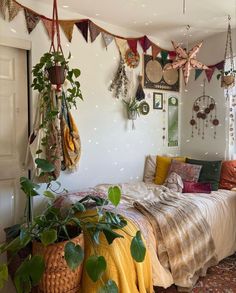 a bed room with a neatly made bed and hanging plants