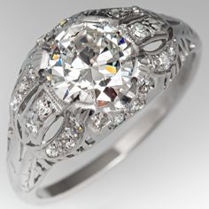 an antique style diamond ring with filigrees