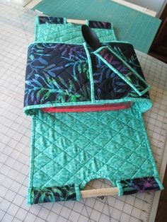 a piece of quilted material sitting on top of a cutting board