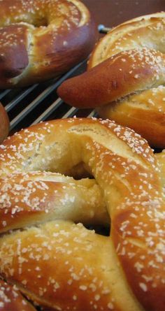 several pretzels sitting on top of a rack with sesame seed sprinkles