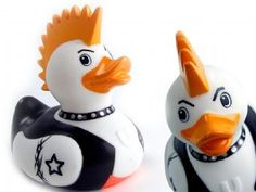 two rubber ducks are dressed in black and white