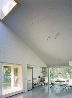 an open room with white walls and wood flooring on the ceiling is filled with sunlight