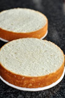 two cakes sitting on top of a black counter