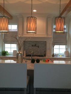 two lights hanging from the ceiling in a kitchen