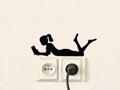 a woman laying on top of an electrical outlet