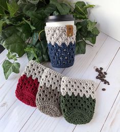 three crocheted coffee cups sitting next to each other on top of a table