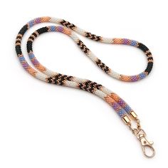 an orange, white and black dog leash on a white background