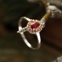 Beautifully marrying a little vintage inspiration with a boho chic edge, meet our sterling silver Rosmerta Ring. Featuring a blood red cubic zirconia centre surrounded by dainty peach stones and set into a delicate band, she is a true Dixi enchantress. This ring is named after the celtic Goddess Rosmerta; known as 'The Great Provider', she invokes fertility and wealth. MaterialSterling SilverCubic Zirconia SizingRing Sizes Available - 15.75mm [USA 5], 16.25mm [USA 6], 17.25mm [USA 7], 18.25mm [U Bohemian Red Anniversary Rings, Spiritual Red Rings For Wedding, Vintage Halo Design Jewelry For Gifts, Bohemian Sterling Silver Ruby Ring For Anniversary, Ruby Ring With Halo Design For Gift, Silver Ruby Ring With Halo As Gift, Sterling Silver Ruby Ring With Halo Design, Sterling Silver Ruby Ring With Halo Design For Gift, Bohemian Wedding Crystal Ring With Birthstone