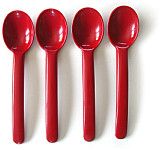 five red plastic spoons lined up in a row