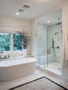 a bathroom with a tub, shower and rug in the middle of it is shown